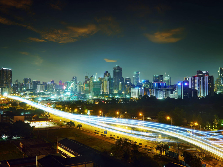 Abstract and car lighttrail background, city skyline downtown background and highway interchanged night view